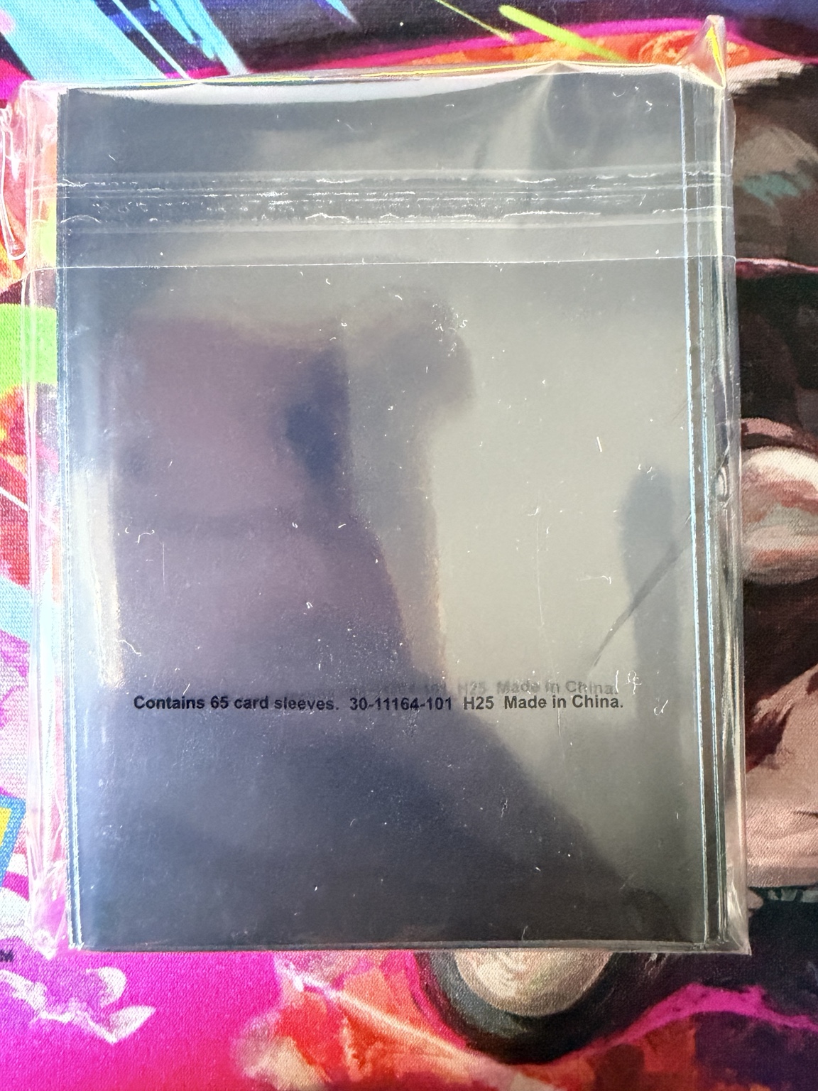 Back of Pokémon TCG Mega Dragonite card sleeves showing pack of 65